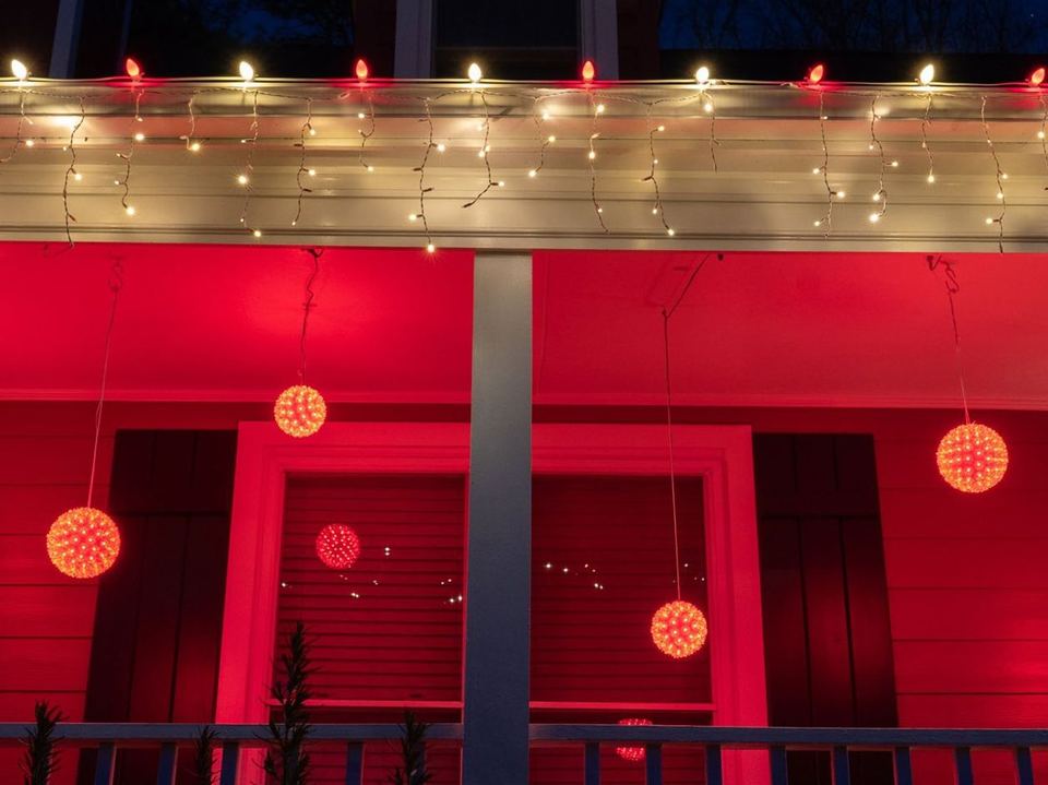 Red starlight spheres hanging along a porch